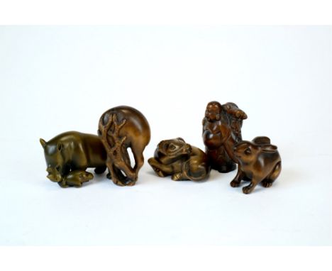Five Japanese boxwood netsuke to include a water buffalo 5cm, a deer 5cm, a hare 4cm, a figure of Hotei 5cm, and a rhinoceros