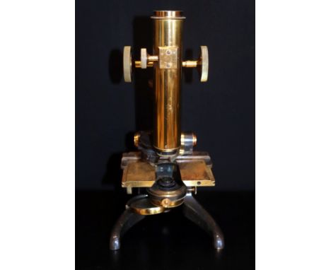 J Swift & Son, Tottenham Court Road, London. 19th century microscope, Lacquered brass and black enamelled, on a horseshoe sta
