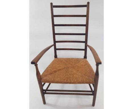 A 20th century oak Arts and Crafts style ladder back chair with rush seating