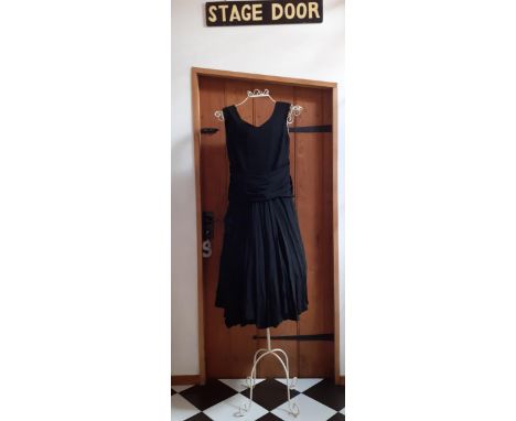 Bob Bugnand, Paris- A black sleeveless cocktail dress with Paris label dating the dress between 1965 and 1973, having appliqu