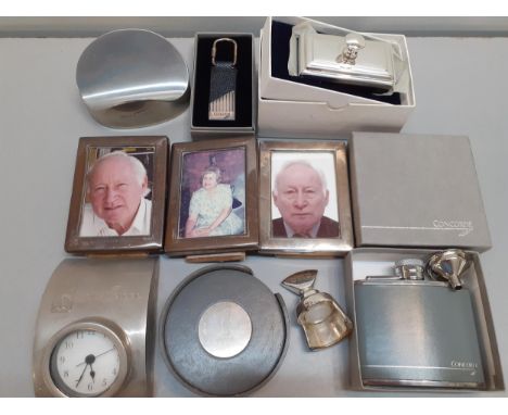 Concorde related items comprising three small silver photo frames, coasters, a wine stopper, a key fob and pen rest together 