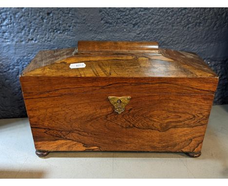 A Georgian rosewood tea caddy of sarcophagus form on four ball feet Location: 3.1 