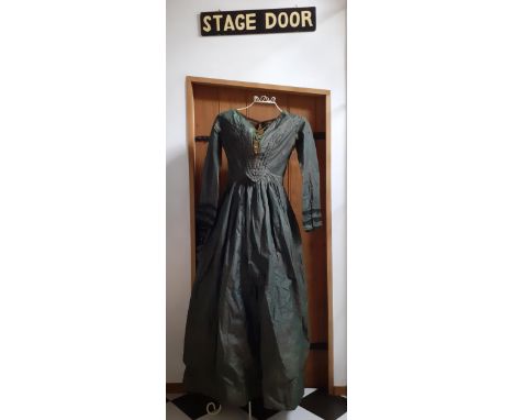 A Victorian ladies hand-made silk dress in dark green having 3 horizontal black lace panels to the cuffs and a green brocade 