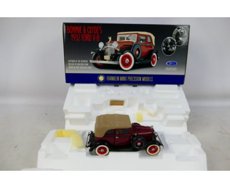 Franklin Mint - A boxed Franklin Mint 1:24 scale Bonnie & Clyde's 1932 Ford V8. The model shows dusty signs of display, but c
