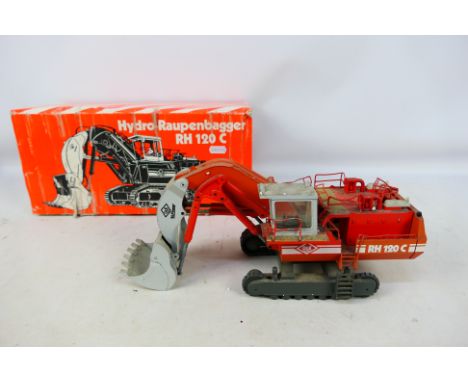 Conrad - A boxed 1:50 scale O&K RH120C Hydraulic Excavator # 2771. The model is dirty from being on display and requires clea