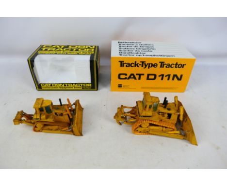 Conrad - NZG - 2 x boxed 1:50 scale construction models, a CAT D9N Tractor # 298 and a CAT D11N Tractor # 2852. The models ar