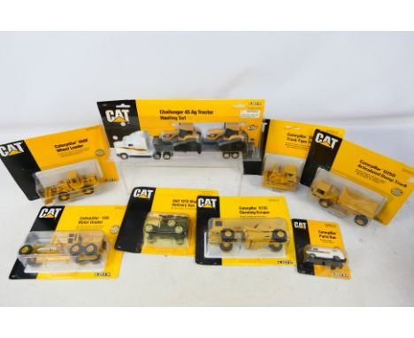 Ertl - A fleet of eight carded Ertl 'Caterpillar' themed diecast models in various scales. Lot includes #1848 12G Motor Grade
