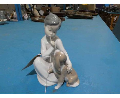 A Lladro model of a Seated Boy and Dog 