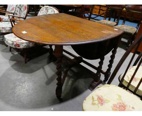 An oak oval top, drop leaf Dining Table on twist gate leg base