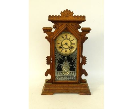 AMERICAN OAK CASED EIGHT DAY MANTLE CLOCK
with a trade label for Clarence, Ansonia Clock Co, New York, the shaped case with a
