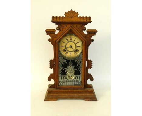 AMERICAN OAK CASED EIGHT DAY MANTLE CLOCK
with a trade label for Clarence, Ansonia Clock Co, New York, the shaped case with a