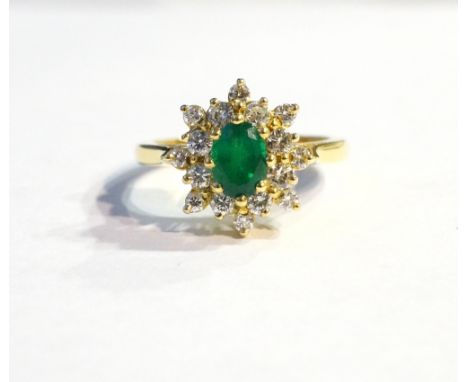 EMERALD AND DIAMOND CLUSTER DRESS RING
the central oval cut emerald approximately 0.7cts in sixteen diamond surround totallin