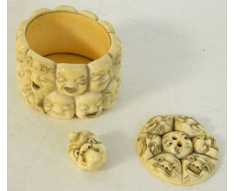 JAPANESE CARVED IVORY OVAL TRINKET BOX
modelled with many faces (possibly Noh masks) to body, including a female demon and an