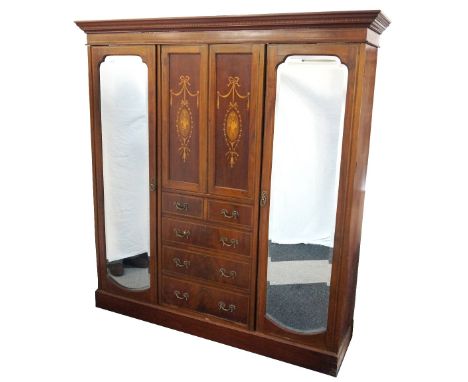 EDWARDIAN MAHOGANY AND INLAID WARDROBE
with a moulded cornice above a pair of inlaid central cupboard doors above two short a