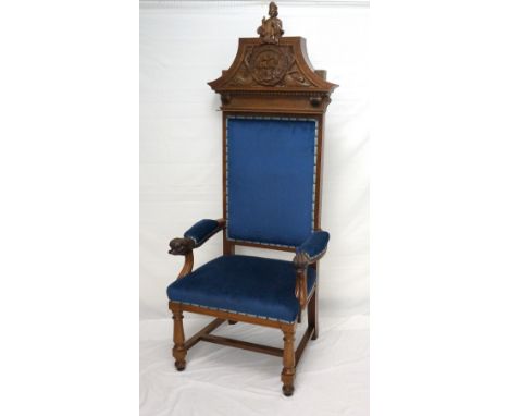 LARGE EDWARDIAN MAHOGANY CARVED OPEN ARMCHAIR
with a shaped carved pediment surmounted by the Bishop of Glasgow, William Wysc