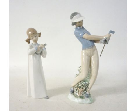 LLADRO FIGURE OF A LADY GOLFER
in a naturalistic setting, 25cm high; together with a Lladro figurine of a young girl in her n