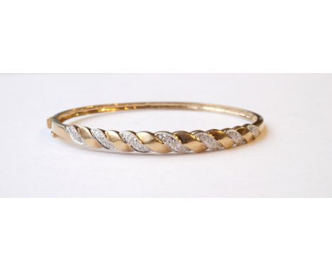 DIAMOND SET BANGLE
in unmarked gold, the diamonds in twist setting