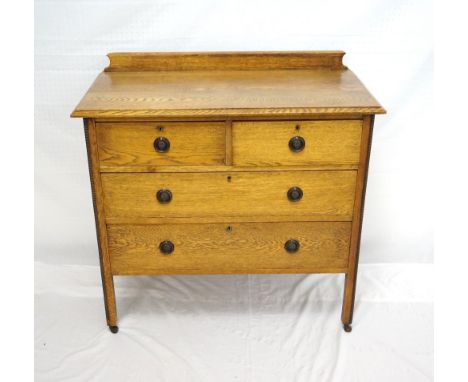 LIGHT OAK DRESSING CHEST
with a shaped raised back above two short and two long drawers, standing on shaped supports with cas