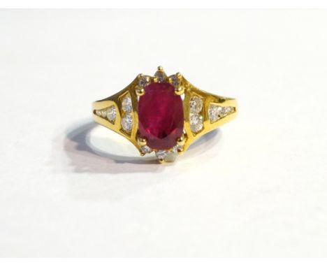 RUBY AND DIAMOND CLUSTER DRESS RING
the central oval cut ruby approximately 1.36cts in multi diamond surround, on eighteen ca