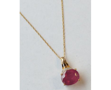 RUBY AND DIAMOND PENDANT
the oval cut ruby approximately 6cts, in nine carat gold and on nine carat gold chain