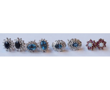 FOUR PAIRS OF GEM SET CLUSTER EARRINGS
comprising a nine carat gold pair set with ruby and opal; a pair of blue topaz and dia