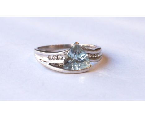 AQUAMARINE AND DIAMOND DRESS RING
the trillion cut aquamarine flanked by diamond set shoulders, on unmarked white gold shank,