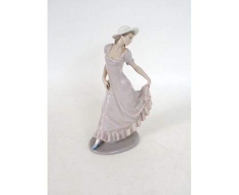 LLADRO PORCELAIN FIGURINE
of a lady wearing a bonnet and full length dress, 29.5cm high