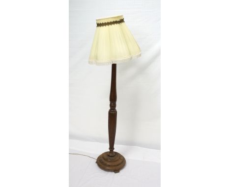 OAK STANDARD LAMP
with a turned reeded tapering column on a circular stepped base, with a shade, 144cm high excluding shade 