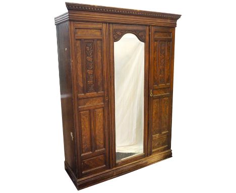 WALNUT TRIPLE DOOR WARDROBE
the moulded dentil cornice above an arched central mirrored door with a bevelled plate, flanked b