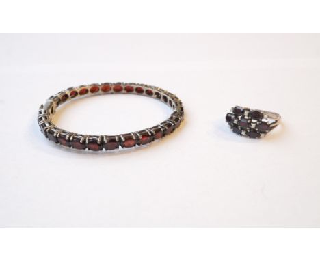 GARNET AND SEED PEARL CLUSTER RING
on silver shank; and a garnet set bangle also in silver
