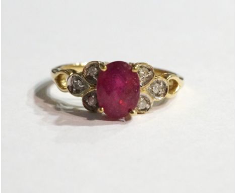 RUBY AND DIAMOND DRESS RING
the central oval cut ruby flanked by three diamonds to each shoulder, on nine carat gold shank, r