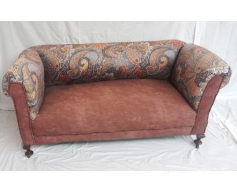 VICTORIAN DROP END SOFA
with an adjustable drop arm, covered in paisley and contrasting chocolate fabric, standing on mahogan