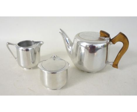 PICQUOT WARE THREE PIECE TEA SERVICE
comprising a tea pot, milk jug and a lidded sugar bowl, in polished stainless steel 