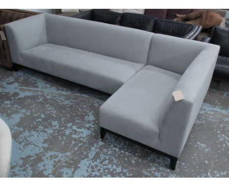 CORNER SOFA, in grey fabric on ebonised supports, 269cm x 136cm.