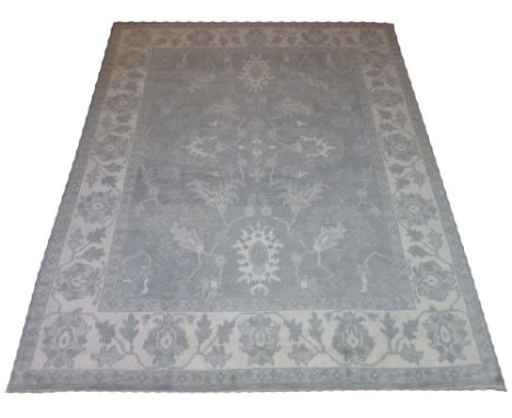 OUSHAK SILVER EN GRIS CARPET, 302cm x 240cm, all over design of palmettes and vines inside a corresponding border.