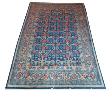 KHOTAN CARPET, 300cm x 195cm, pomegranate design on an aquamarine field inside multiple corresponding bands and borders.