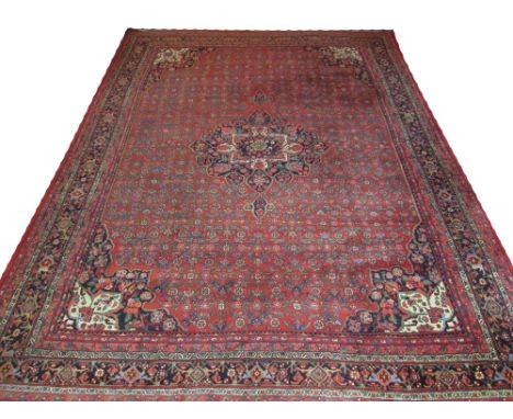 ANTIQUE BIJAR CARPET, 433cm x 317cm, pole medallion on a terracotta field of linear flower heads and vines inside correspondi