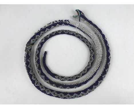 A First World War Ottoman Turkish prisoner of war bead-work snake, 145 cm, (a/f)