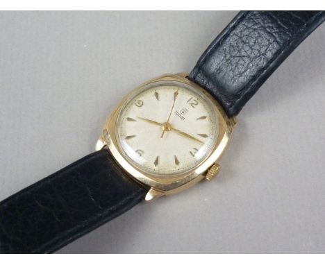 A 1950s Tudor 9ct wrist watch, having radially engine turned circular face with gilt quarter-Arabic chapter, conforming dagge