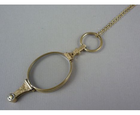 An early 20th Century rolled gold lorgnette, with engraved decoration, on a rolled-gold neck chain