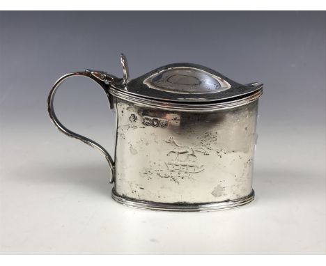 A Victorian silver mustard pot and cover, having engraved armorial crest in the form of a fox passant, with clear glass liner