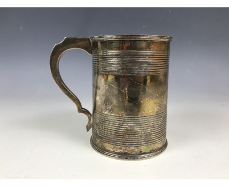 A George IV silver tankard, with reeded decoration, bearing the engraved dedication 'The gift of R. P. Milboum Esqr. to Thoma