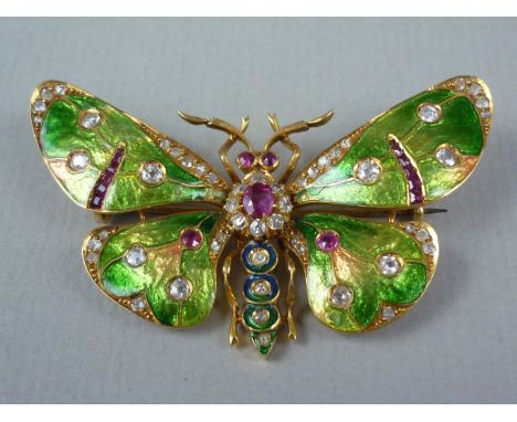 A Belle Epoch ruby and diamond insect brooch modelled as an emerald green butterfly, the thorax claw set in a cluster arrange