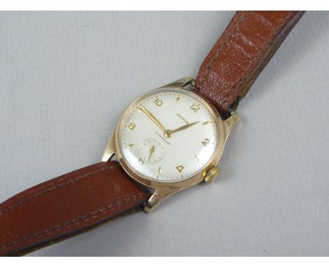 A 1950s 9ct gold Cyma wrist watch, having a calibre R.458 17 jewel movement, brushed silver circular face with subsidiary sec