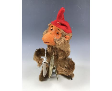 A mid 20th Century clockwork automaton toy monkey playing the cymbals, 16 cm, with lower stage of original carton