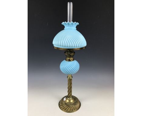 A Victorian brass oil lamp, with spirally reeded column and gadrooned base, with conforming turquoise milk glass reservoir an