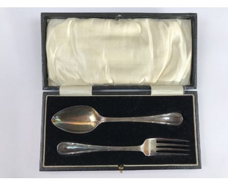 A George V cased silver reed and ribbon pattern Christening fork and spoon set, A. Wilcox, Birmingham, 1932 and Chester, 1922