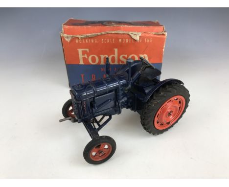 A Chad Valley Co Ltd Working Scale Model of the New Fordson Major tractor, in navy blue with red wheels, in original lithogra