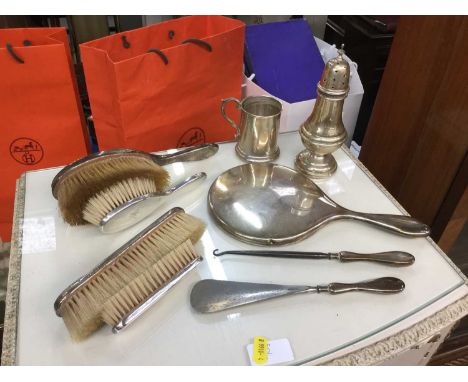 Silver sugar caster, silver christening mug, silver backed brushes and shoe horn and button hook.