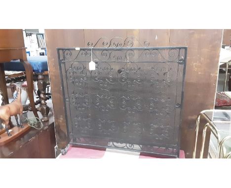 Wrought iron firescreen together with a nest of two brass and glass occasional tables (2)Condition report: 68.5cm wide, 70cm 